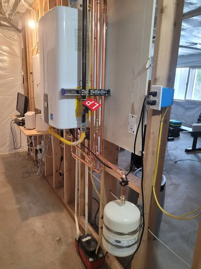 Licensed plumber repairing a kitchen sink in Alma